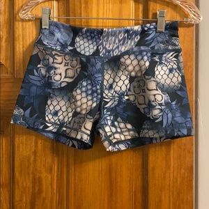 Blue athletic shorts with pineapples